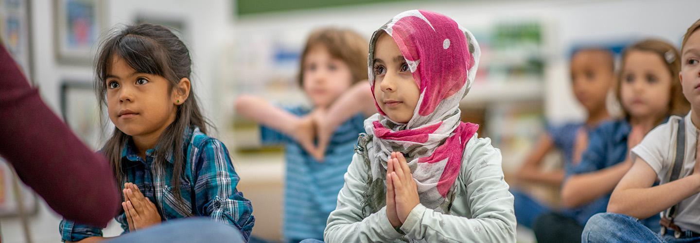 Preschool children practicing mindfulness in a classroom