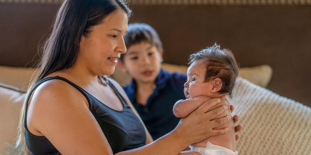 a young mother holds her child