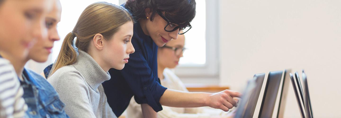 a young woman learning computer coding