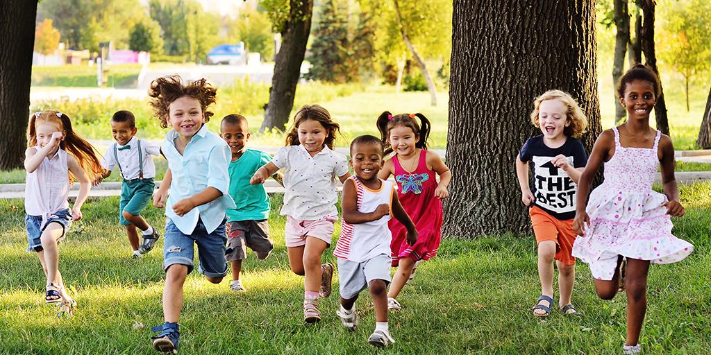 a group of children running and playing