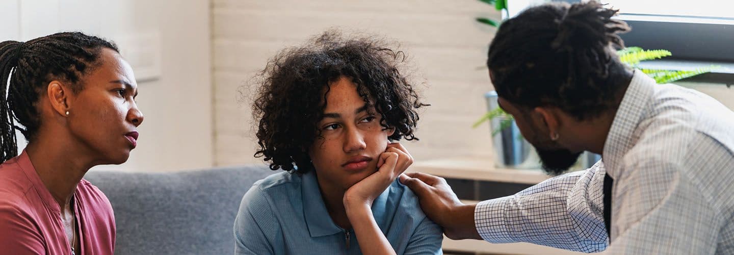 a woman and her teen son talk to a therapist
