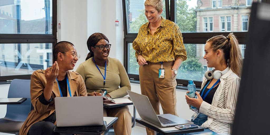 Group of medical students in a classroom in a hospital studying for their medical degree. They are at a healthcare facility in Newcastle Upon Tyne, North East England. A female teacher is supervising the students.