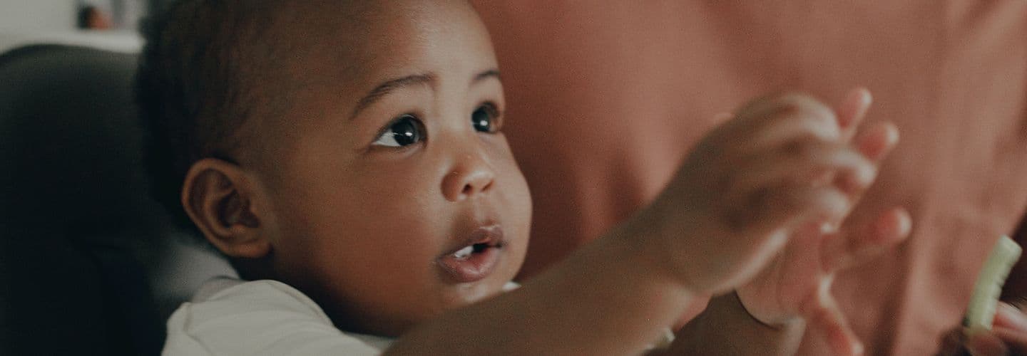 a young baby looks off camera